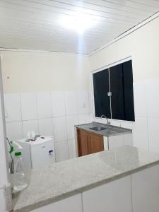 a kitchen with a sink and a counter top at Apart Hotel M6D in Rio Branco