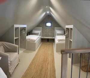 a attic room with two beds and a table at Lark in Schleibnitz