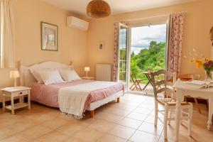 a bedroom with a bed and a sliding glass door at Chambres d'hôte La Pradelle in Le Vigan