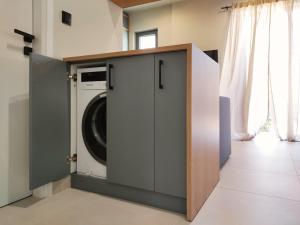 a laundry room with a washer and dryer at Billie's Holiday in Preveza