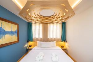 una camera con letto e soffitto in legno di Limehouse Library Hotel a Londra