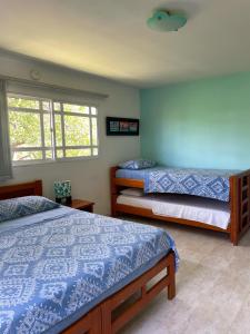 A bed or beds in a room at Posada Nativa Bernard Place