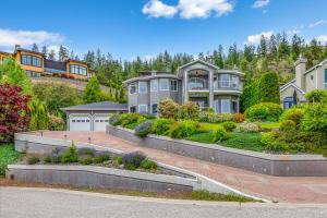 a large house with a garden in front of it at Casa Grande Lakeview House in West Kelowna