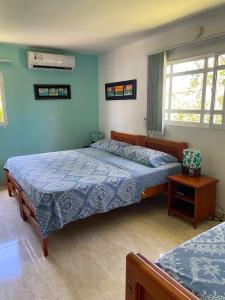 A bed or beds in a room at Posada Nativa Bernard Place