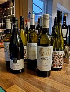 a group of bottles of wine sitting on a counter at The Bull Inn in Woolpit