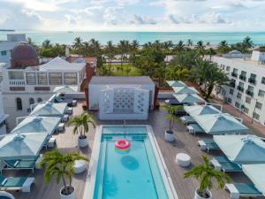 an aerial view of a hotel with a pool and umbrellas at Dream South Beach, Part Of Hyatt in Miami Beach