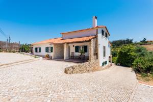 a house with a stone driveway in front of it at Vale de Abrantes in Lourinhã
