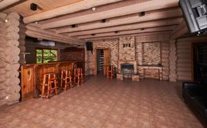 a large living room with a fireplace and wooden ceilings at Viesu nams Krauklīši in Tīnūži