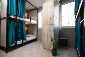 A bed or beds in a room at Bedway Athens Hostel