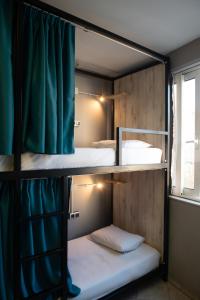 A bed or beds in a room at Bedway Athens Hostel
