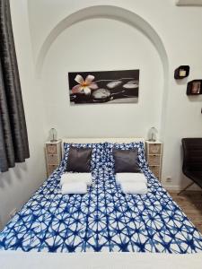 a bedroom with a blue and white bed with two pillows at Green garden in Zagreb