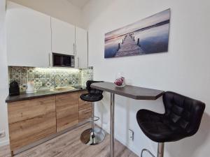a kitchen with a counter and a bar stool at Green garden in Zagreb