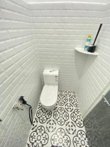 a bathroom with a toilet and a tile floor at HZ HOMESTAY PENDANG in Pendang