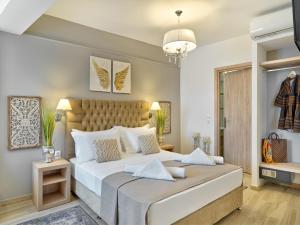 a bedroom with a large bed and a chandelier at ACROPOLIS CITY LIFE BOUTIQUE HOTEL in Athens