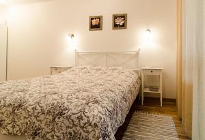 a bedroom with a bed and two night stands at Lovely Dream Apartment in Vilnius