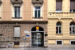 a building with an open door with graffiti on it at Green garden in Zagreb