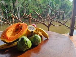 a plate of fruit and vegetables on a table at Camu camu jungle villa on Aguajale lake - supboard&vinyl in Iquitos