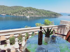 a table with a bottle of wine on a balcony at Apartments Sponga in Polače