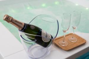 a bottle of champagne in a bucket with two glasses at Centro Storico Bed e Breakfast in Pozzuoli