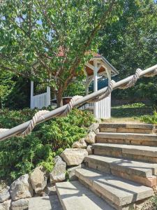 a rope leading to a set of stairs with a gazebo at Májusfa in Balatonszárszó