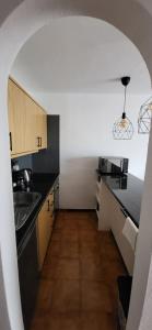 a kitchen with a sink and a counter top at Albatros Tenerife Golf Sea View in San Miguel de Abona