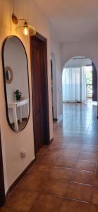 a hallway with a mirror and a tile floor at Albatros Tenerife Golf Sea View in San Miguel de Abona