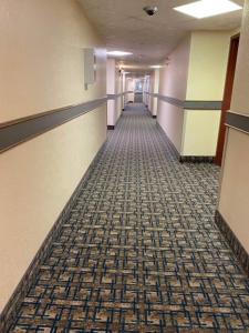a hallway of a hospital with a carpeted floor at Gold Circle Inn in Lloydminster