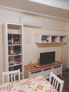 a room with a desk with a computer on it at La casa del cocchiere in Palermo