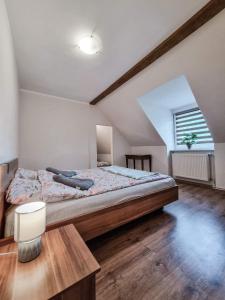 a bedroom with a large bed in a attic at Chill House in Mrągowo