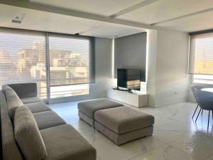 a living room with a couch and a flat screen tv at Luxury Apartment in Nicosia By Platform 357 in Nicosia