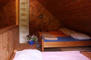 a bedroom with a bed in a wooden cabin at Straniger Alm in Stranig