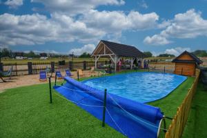 a large pool with a gazebo and a playground at APARTAMENT Białka Tatrzańska K1- na terenie SUN&SNOW in Białka Tatrzanska