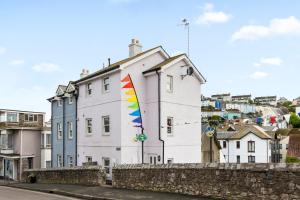 a building with a colorful kite on the side of it at A modern and cosy apartment just yards from Brixham’s bustling harbourside in Brixham
