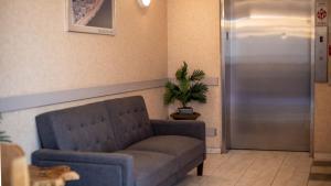 a living room with a couch and a potted plant at Ocean 1 Hotel & Suites Ocean City in Ocean City