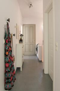 a room with a hallway with a dress on the wall at Vassiliki Residence Skyros Island in Skiros