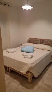 a bedroom with a large bed with towels on it at Le Farfalle Appartamento in villa trifamiliare in Porto Istana