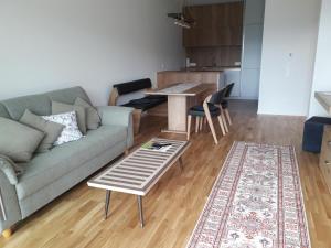 a living room with a couch and a table at Apartment Augenweide in Annenheim