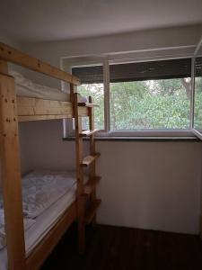 a bedroom with two bunk beds and a window at Seeblick Bungalow in Arendsee