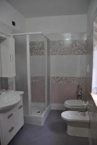 a bathroom with a shower and a toilet and a sink at B&B Casa Letizia in Trentinara