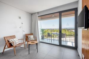 a living room with a view of a balcony at Apartamentos Marvela in Lagos