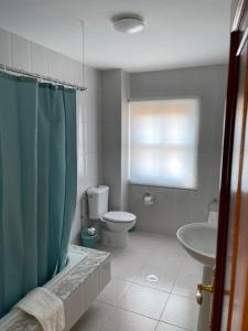 a bathroom with a toilet and a sink at PISO A GAIVOTA in Cee +3 photos