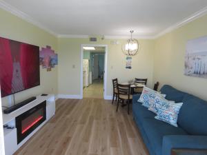 a living room with a blue couch and a table at 2 Story Direct Oceanfront Penthouse- Sandy Beach Resort 1116- Sleeps 6! in Myrtle Beach