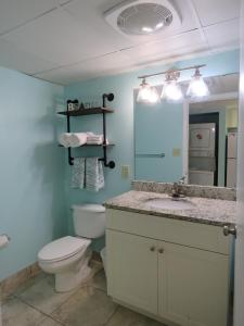 a bathroom with a toilet and a sink and a mirror at 2 Story Direct Oceanfront Penthouse- Sandy Beach Resort 1116- Sleeps 6! in Myrtle Beach