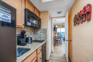a kitchen with a sink and a counter top at Spacious Ocean View Suite With Beautiful Updates! - Ocean Dunes Tower 2 Unit 6121 - Sleeps 6 Guests! in Myrtle Beach