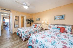 a bedroom with two beds and a ceiling fan at Spacious Ocean View Suite With Beautiful Updates! - Ocean Dunes Tower 2 Unit 6121 - Sleeps 6 Guests! in Myrtle Beach +18 photos