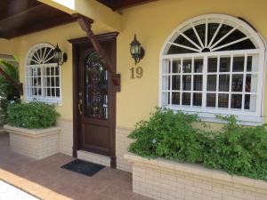 a house with a wooden door and windows at Sofia's B&B Hostal Boutique in Panama City