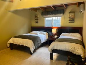 a bedroom with two beds and a window at Sofia's B&B Hostal Boutique in Panama City +34 photos