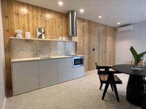 a kitchen with a sink and a table at Santa Clara 1828 in Ponta Delgada