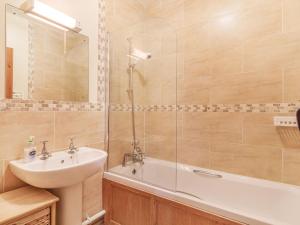 a bathroom with a sink and a tub and a shower at Punch Cottage in Little Glenham +17 photos