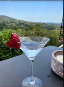 a strawberry in a martini glass with a cup of coffee at Entire Cottage The Nest, Omeath near Carlingford 